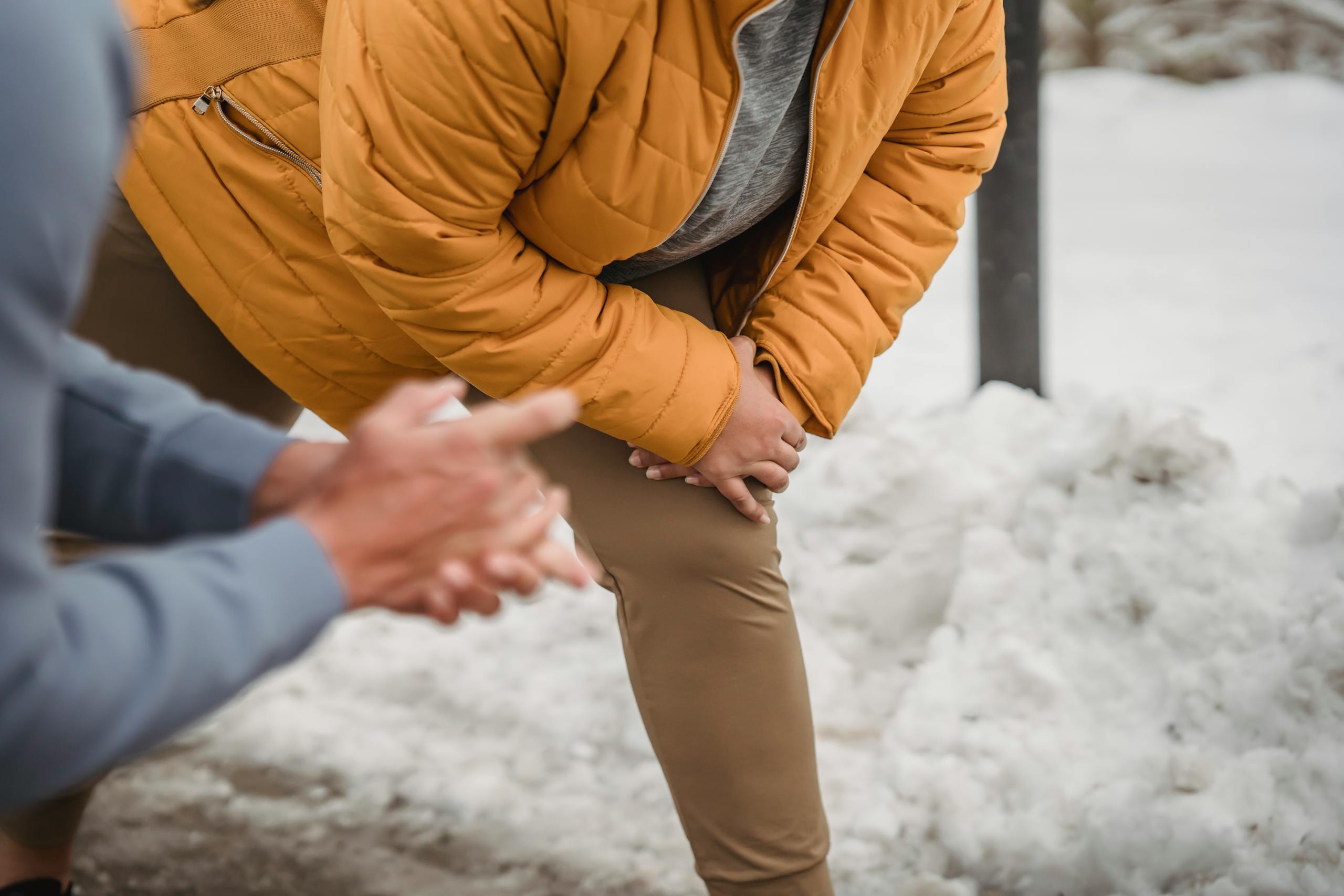 A person in a yellow jacket exercises outdoors in winter, showcasing fitness and motivation.